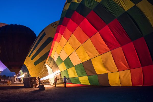 Gas burner filling hot air balloons in the early morning dawn